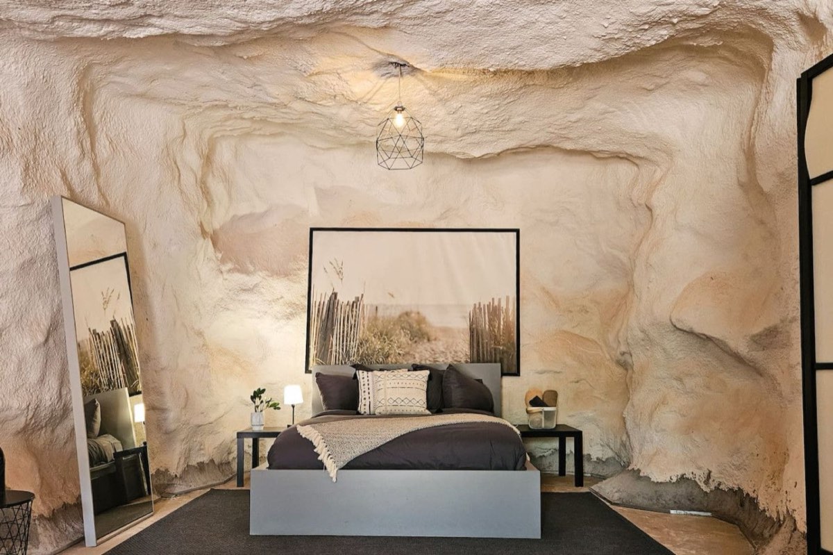 A cave chamber carved into the Navajo sandstone, bed beneath the arched roof