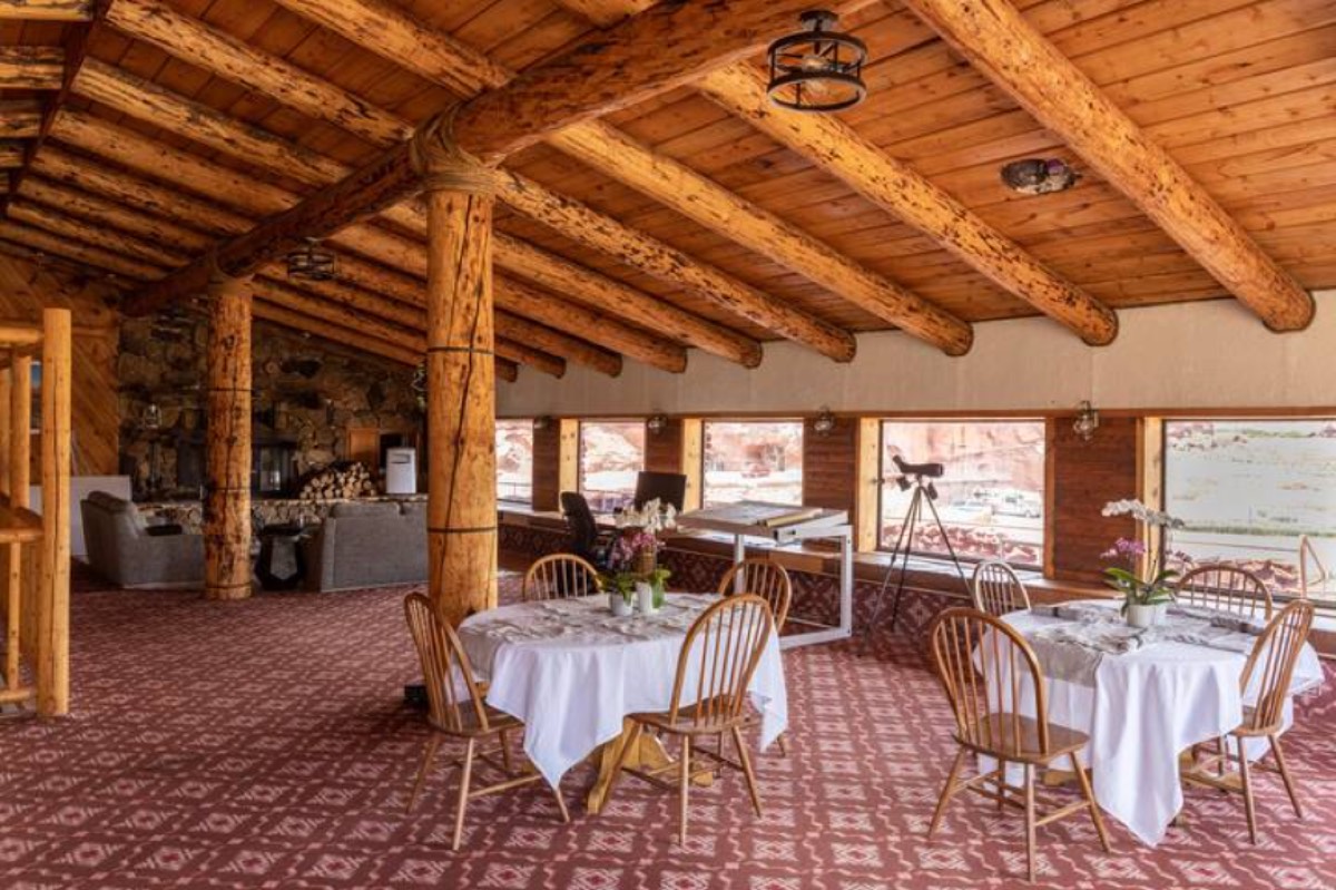 The dining room of the Ranch House beneath exposed log beams